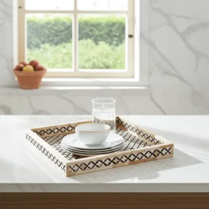 Artisan bone inlay lattice pattern tray used for jewelry display in a bright room
