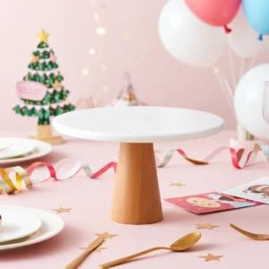 White marble cake stand supported by solid wooden base