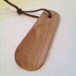 Wooden shoe horn with leather stripe