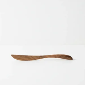 acacia wood butter knife used as a wooden cheese spreader