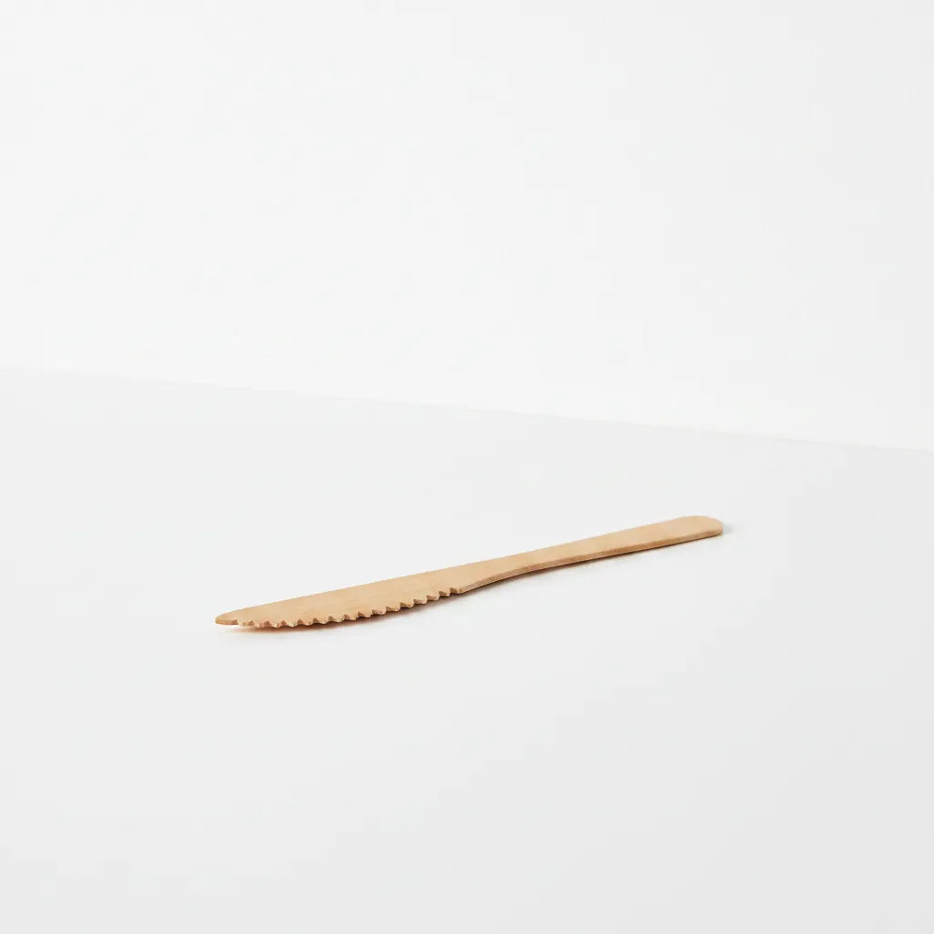 handmade wooden butter knife used as a jam and cheese spreader