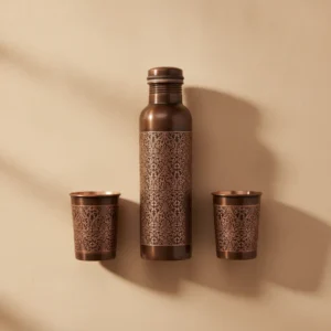 antique copper bottle and tumbler set with ornamental floral scroll pattern