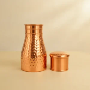 hammered copper water pot with rounded body and narrow neck for water storage and serving